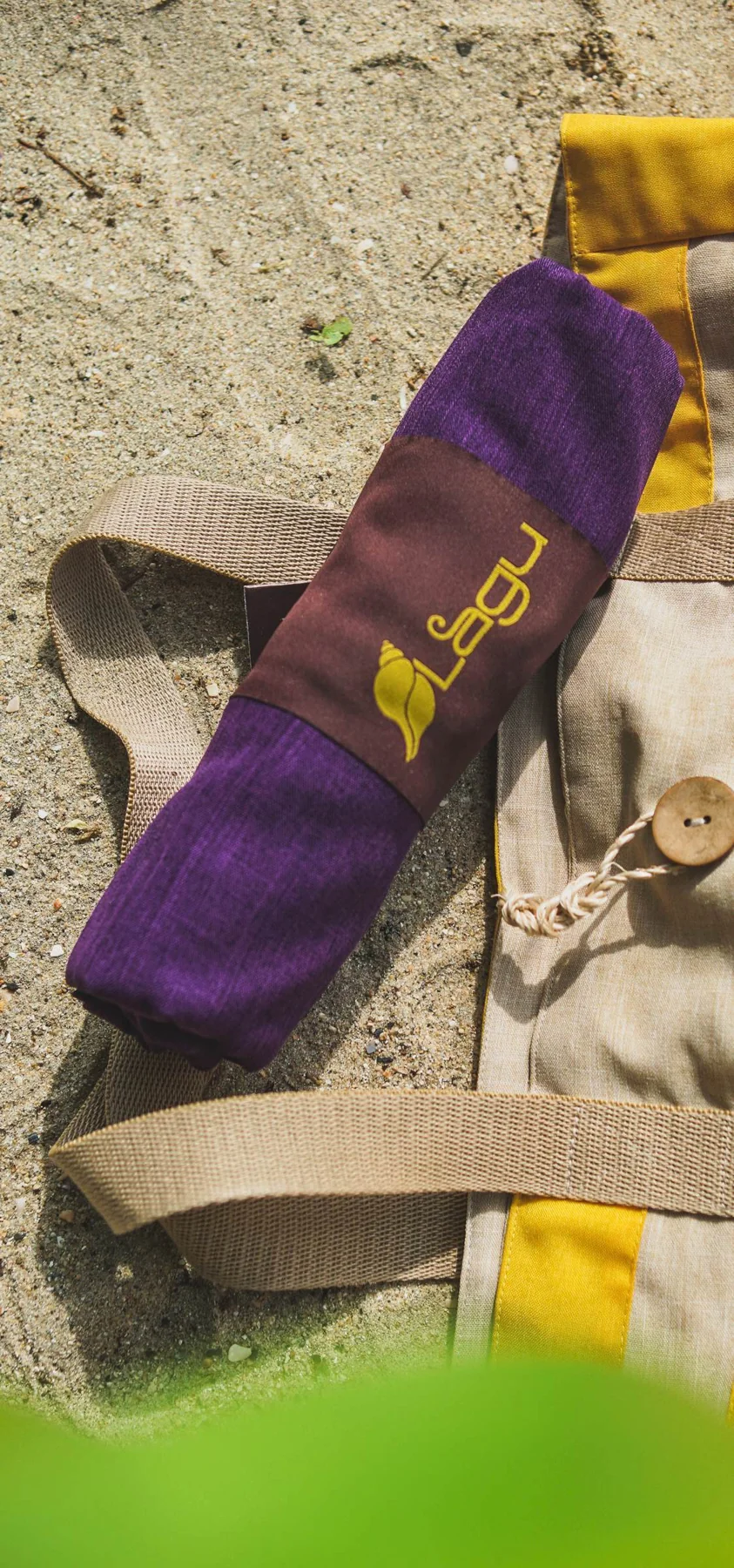 A rolled Lagu blanket packed for a day by the sea